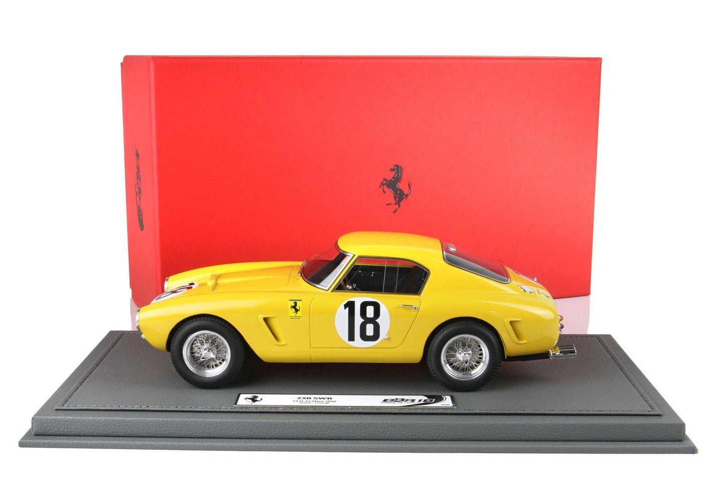 Yellow Ferrari 250 SWB model car with number 18 displayed on racing base, offered on Vroomi