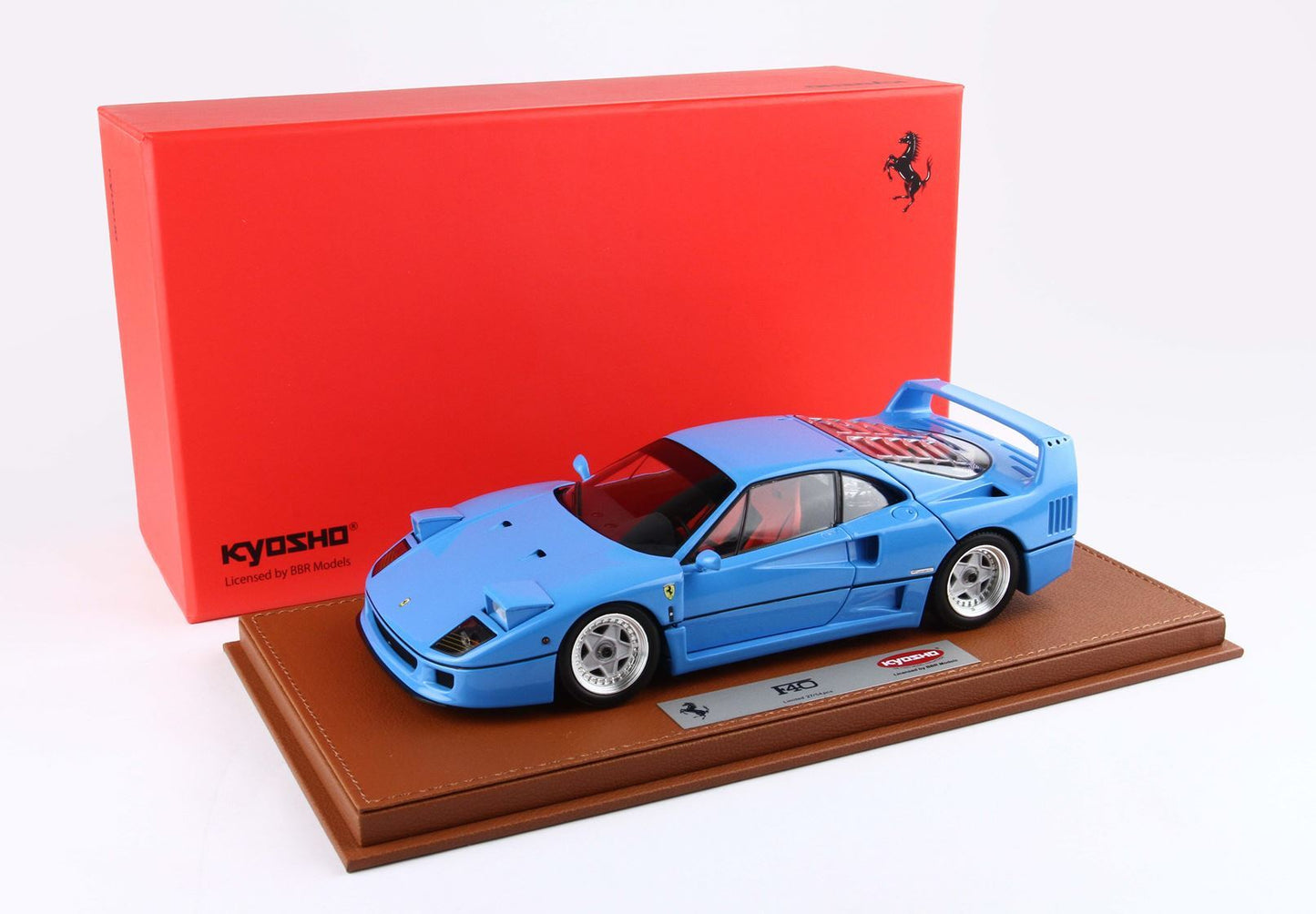 Blue Ferrari F40 model car on leather base with red Kyosho box, available on Vroomi
