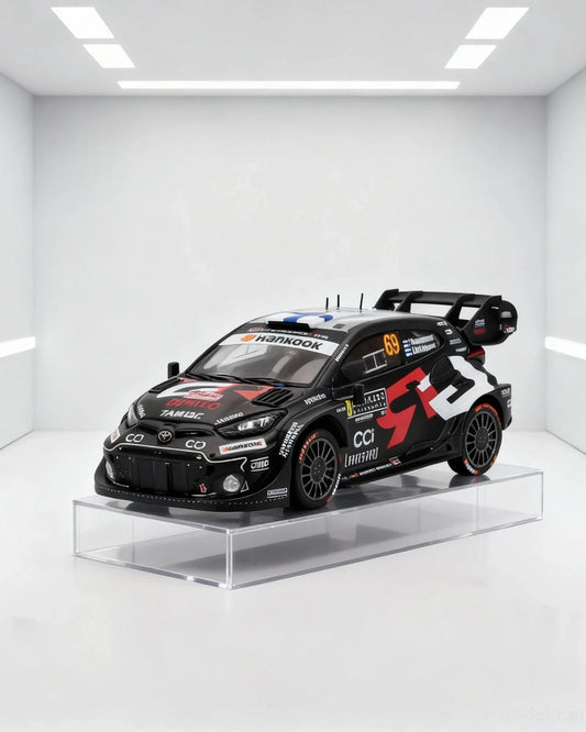 Black Toyota Yaris WRC race car model on clear platform, racing details, available on Vroomi