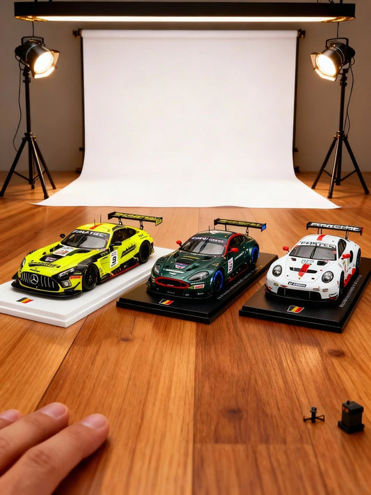 Three detailed racing car models on display with studio lights and white backdrop, available on Vroomi