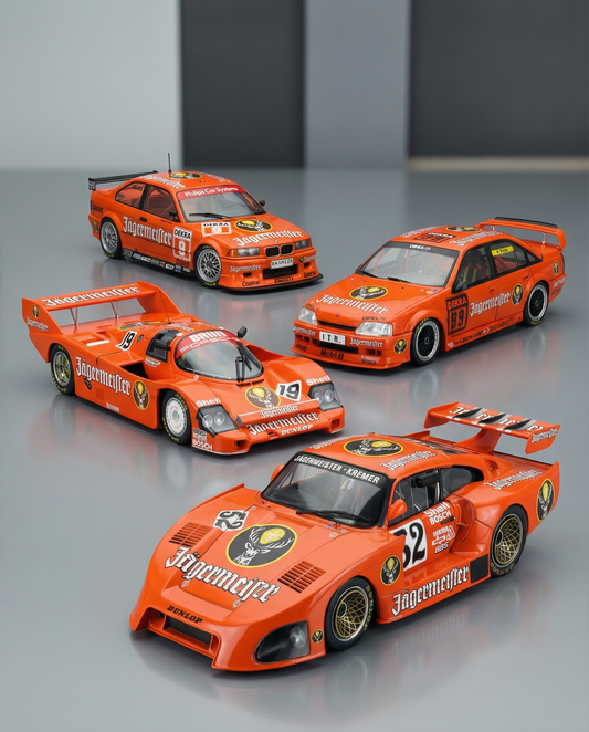 A group of 4 scale model cars with Jagermeister sponsor and liveries