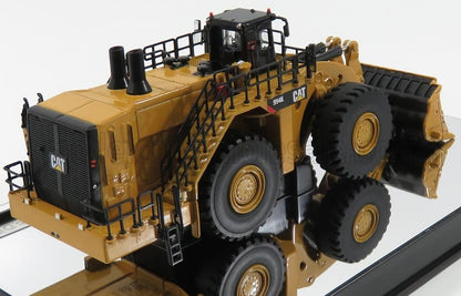 Scale model of a yellow CAT 994K wheel loader with detailed railings and tires, offered through Vroomi