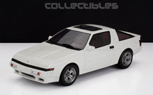 White Mitsubishi Starion vintage sports car model displayed against black and white backdrop, available on Vroomi