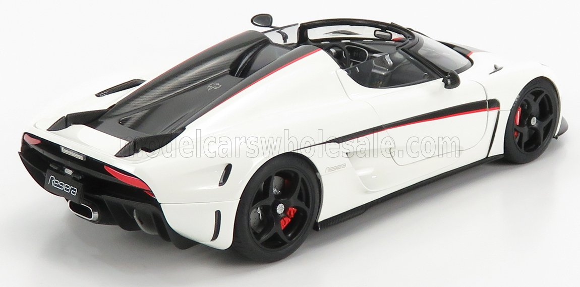 White Koenigsegg Regera convertible sports car with black and red accents, shown from rear side, available on Vroomi