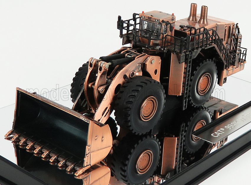Detailed bronze model of a CAT 990K wheel loader displayed on reflective surface, now featured on Vroomi