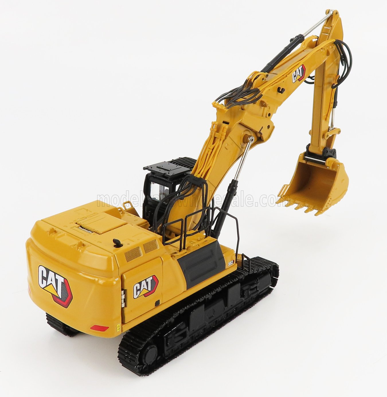 Yellow CAT 352 hydraulic excavator model with black tracks, detailed metal arm and bucket, offered through Vroomi