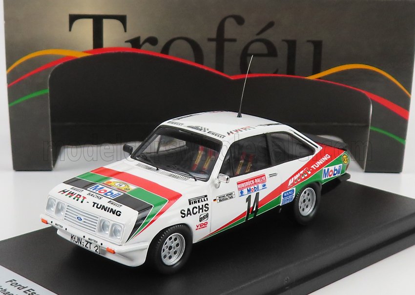 White vintage Ford Escort rally model car with colorful sponsor decals on black display, available on Vroomi