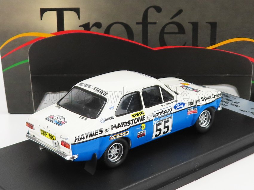 Ford Escort MK1 rally car model in white and blue with racing decals, number 55, showcased on a display stand accessible on Vroomi