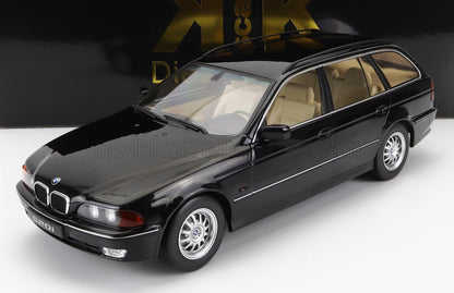 Black BMW 520i model car with beige interior on white surface, sold via Vroomi platform