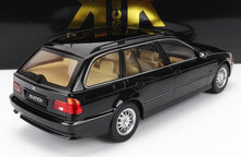 Black BMW 520i classic station wagon model with beige interior, available on Vroomi