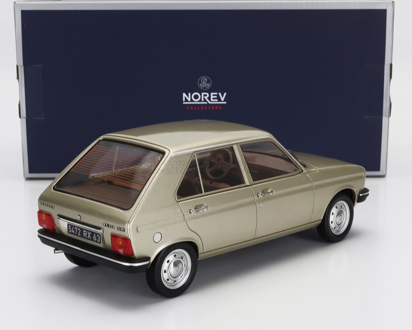 Gold Peugeot 104 ZR scale model car by Norev, showcased with Vroomi for collectors.