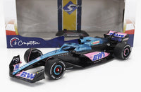 Coche a escala Alpine A523 de F1 con decoración de presentación, con branding de BWT y Castrol, presentado con packaging de Vroomi