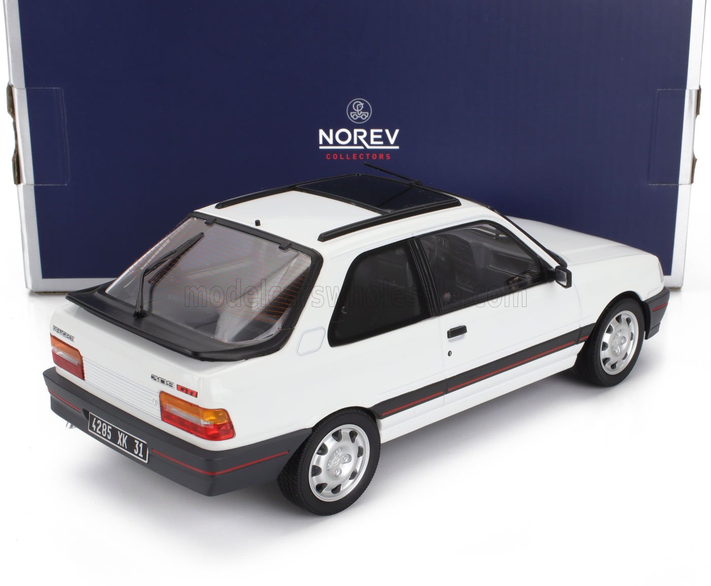 White Peugeot 309 GTI model car with sunroof and black trim, displayed with Norev Collectors box, also on Vroomi