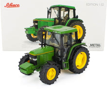 Green and yellow Schuco 1:32 scale tractor model with metal and plastic parts, available at Vroomi