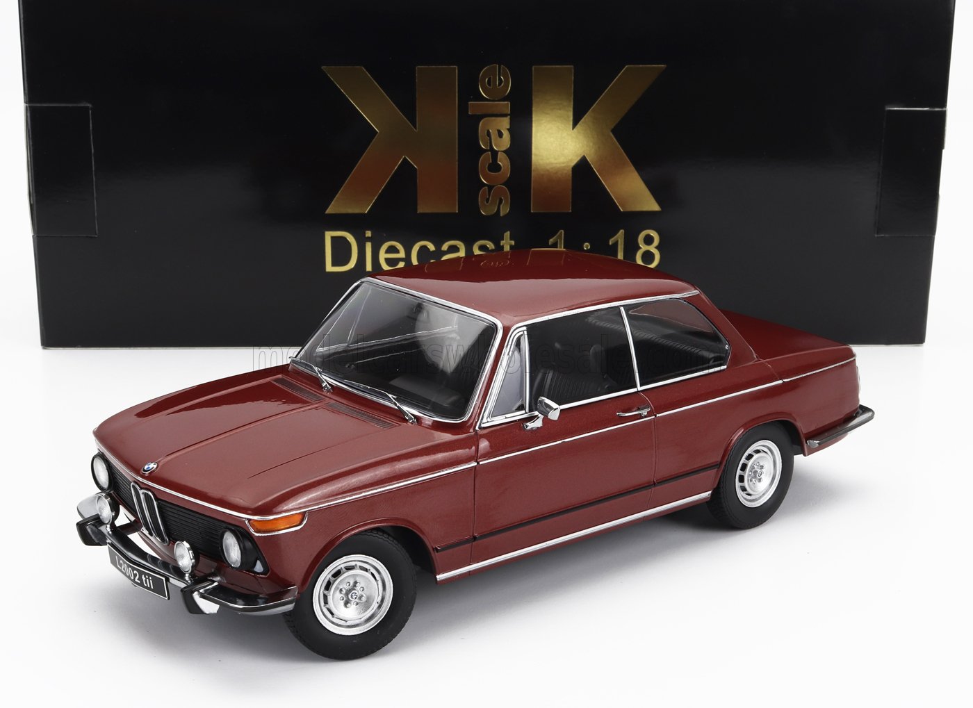 1:18 scale diecast model of a maroon BMW 2002 tii with black interior, displayed in front of KK Scale packaging, available on Vroomi