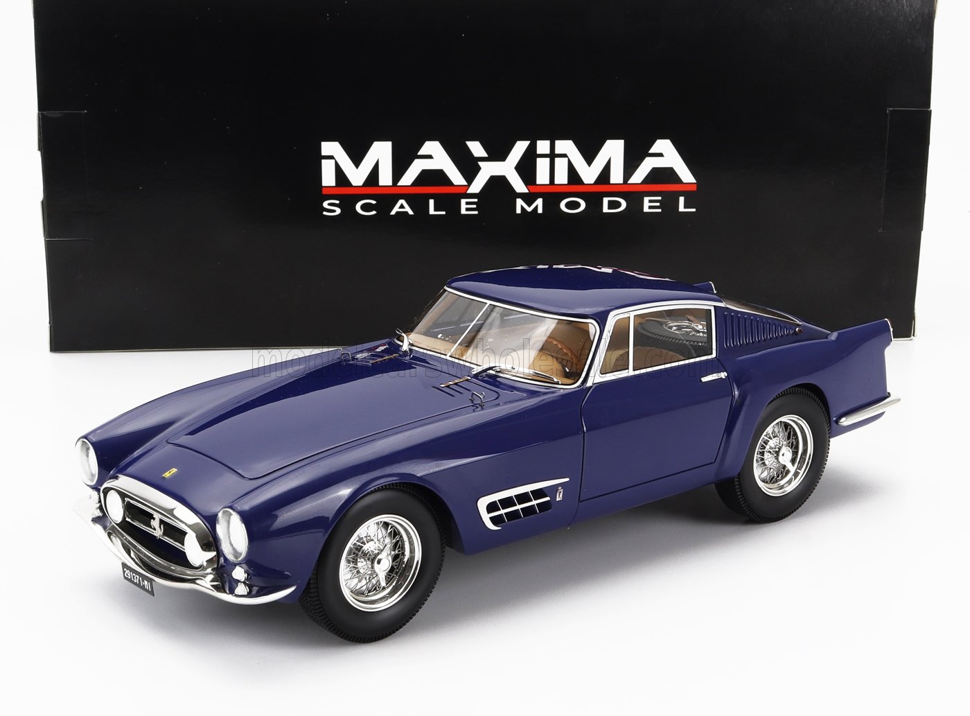 Blue Ferrari scale model car with chrome details displayed in front of MAXiMA Scale Model box, available through Vroomi