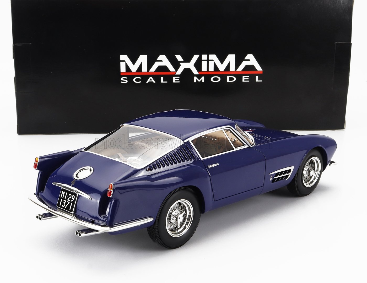 Blue vintage scale model car with wire wheels displayed in front of Maxima Scale Model box, available on Vroomi