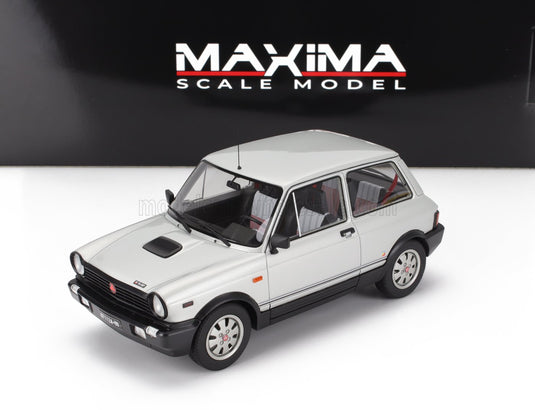 White scale model car from Vroomi, detailed with black trim and classic design
