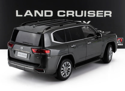 Dark gray Toyota Land Cruiser ZX SUV model on white surface with Land Cruiser signage, offered on Vroomi
