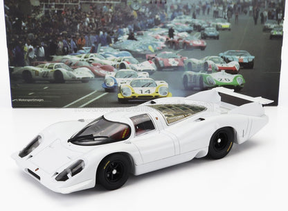 White Porsche 917K race car model with black wheels, displayed with vintage race photo backdrop, available via Vroomi