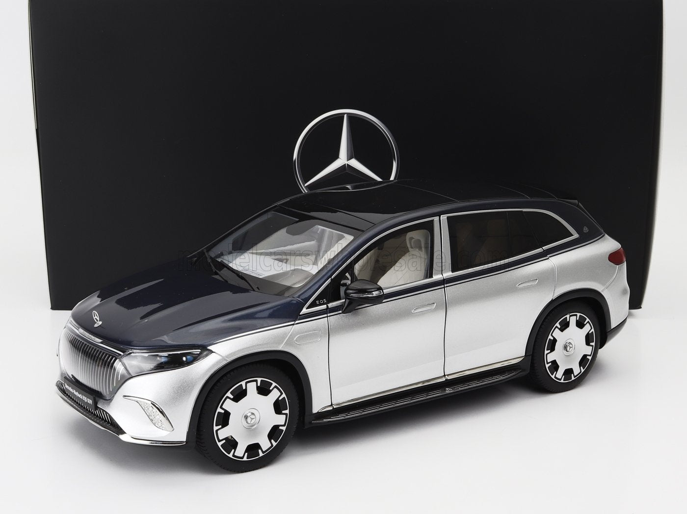 Silver and black Mercedes-Benz EQS SUV model car displayed with Mercedes logo, offered on Vroomi