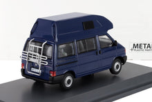 Blue VW California camper van model with raised roof and rear metal rack, showcased on a display stand, available on Vroomi