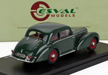Dark green vintage model car with red wheels displayed on black base, offered on Vroomi