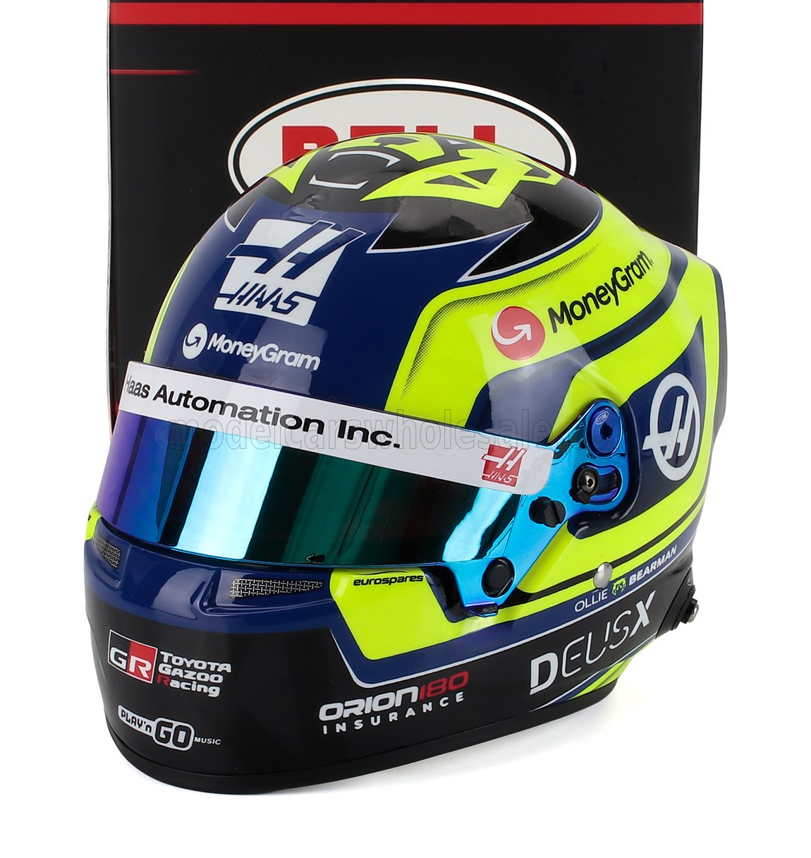 Haas F1 racing helmet scale model car collectible by Vroomi, featuring MoneyGram & DEUSX branding