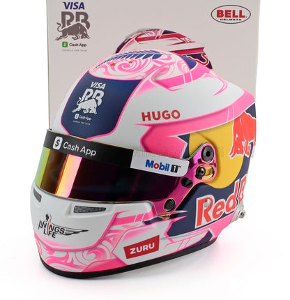 Hugo's vibrant pink and blue F1 helmet scale model car collectible by Vroomi, featuring Red Bull, Visa, and Mobil 1 branding.