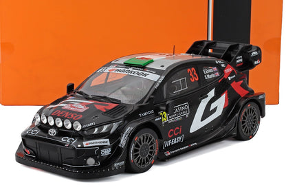 Black and silver Toyota Gazoo Racing rally car model with red accents, decals, and roof lights, offered on Vroomi