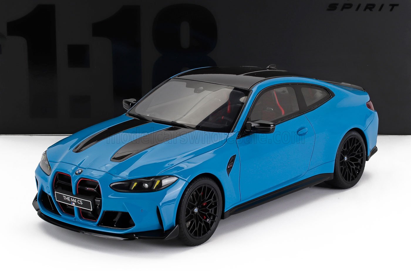 Blue BMW M4 CS scale model car with black accents and detailed interior, available at Vroomi