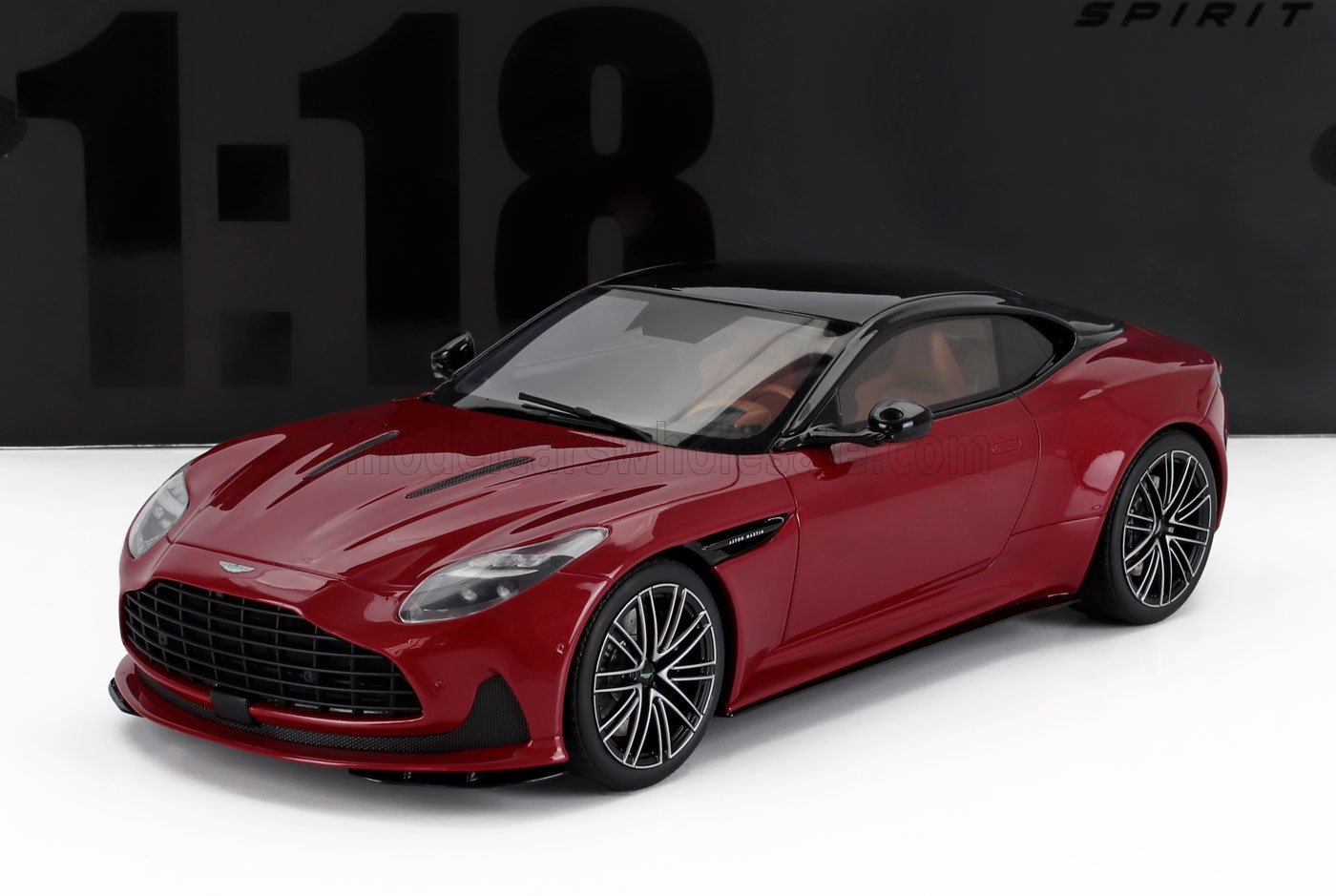 Red Aston Martin sports car model with black roof and detailed wheels, now featured on Vroomi
