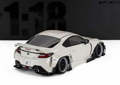 White 1:18 scale Toyota GR86 model car with wide body kit and black wheels, available at Vroomi