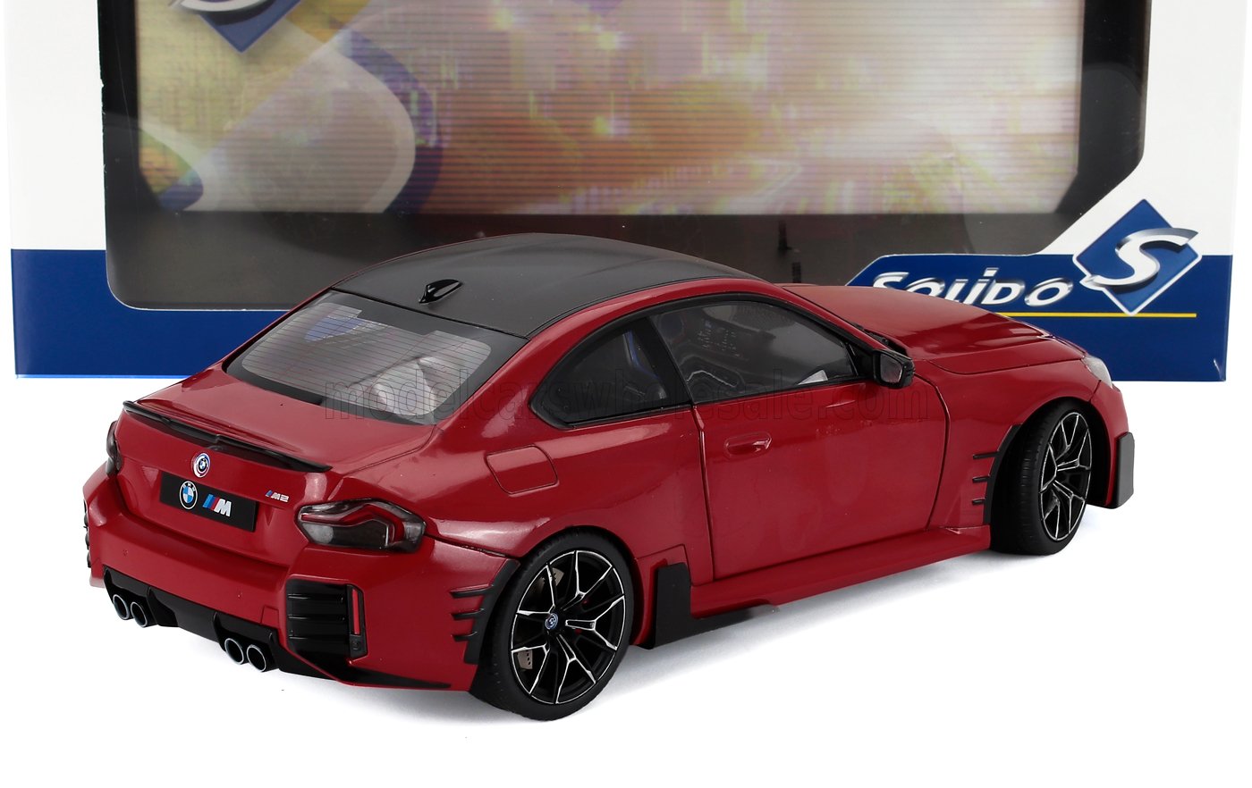 Red BMW M2 model car with black roof and detailed rims, displayed with Solido packaging, available on Vroomi