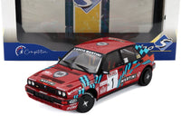 Modellino in scala Lancia Delta Martini rally rosso con decalcomanie sponsor, esposto nella confezione Vroomi