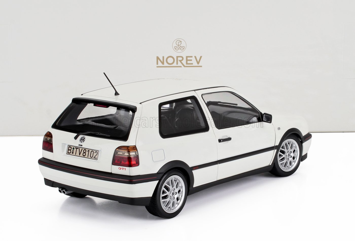 White Volkswagen Golf GTI hatchback model with silver wheels, detailed rear view, offered on Vroomi