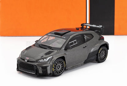 Matte gray Toyota GR Yaris rally car model with black spoiler, racing decals, available on Vroomi