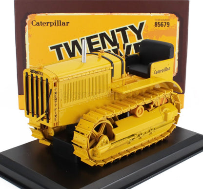 Yellow Caterpillar Twenty Five tractor model on black base with vintage packaging, available via Vroomi