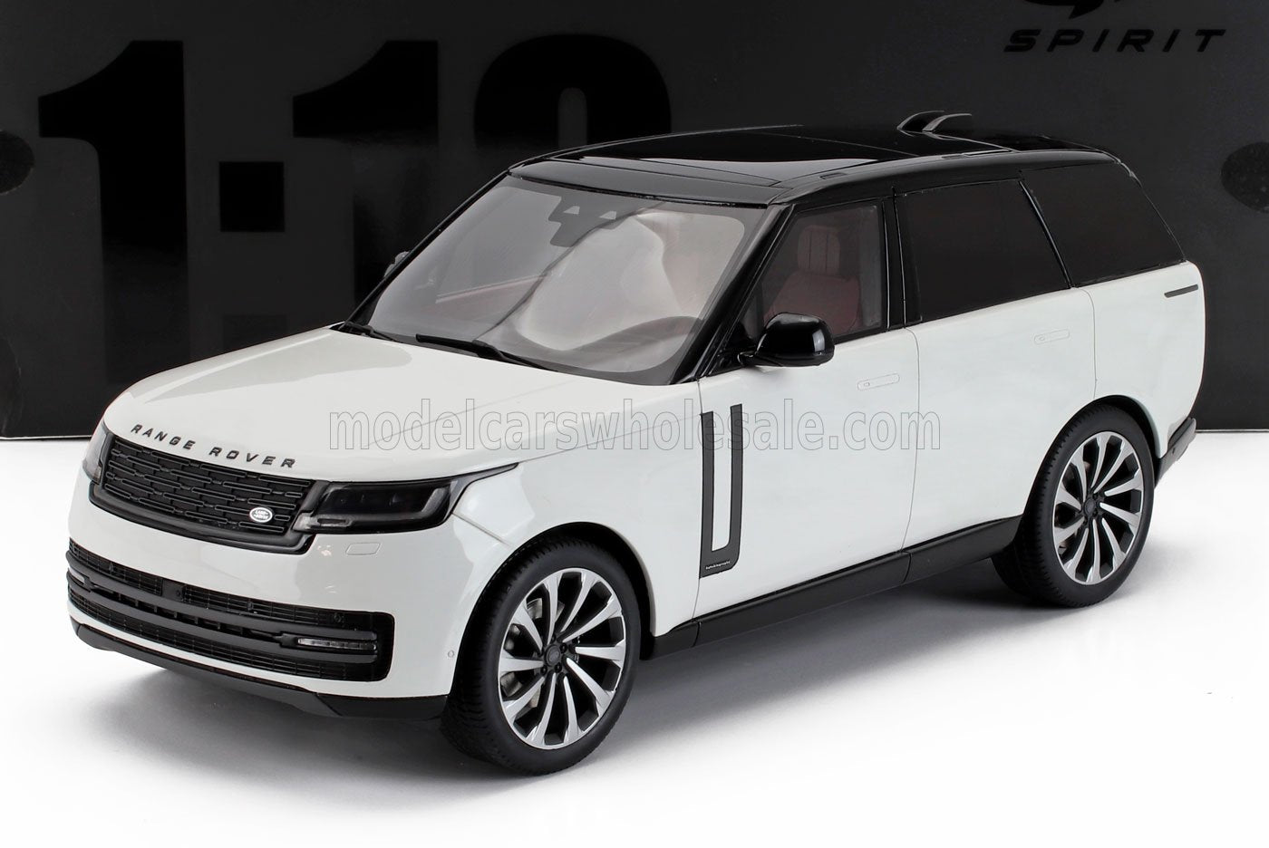 White and black 1:18 scale Range Rover SUV model with detailed wheels and interior, available at Vroomi