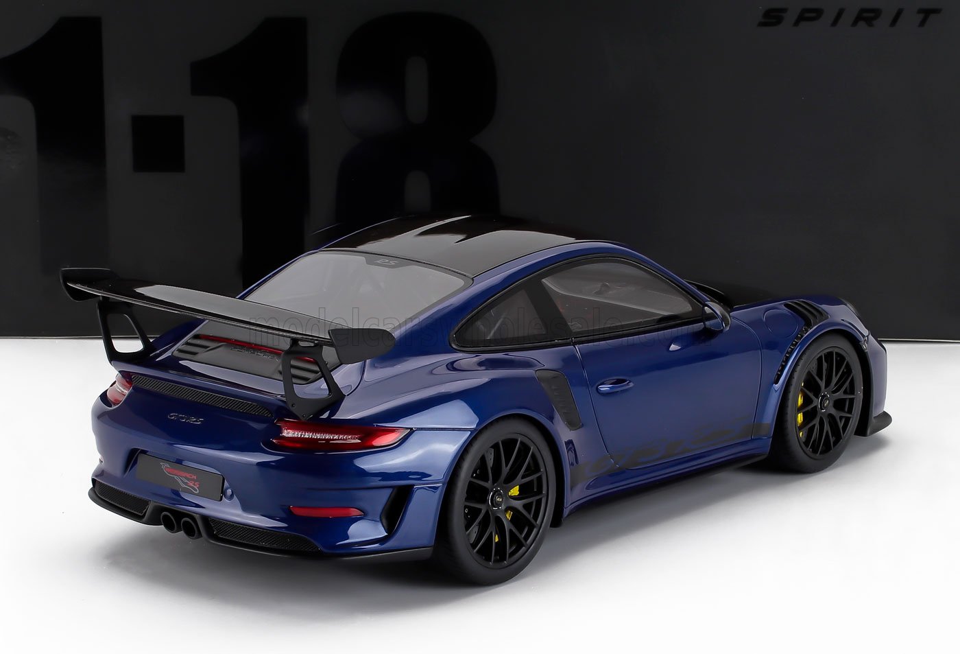 Blue 1:18 scale Porsche 911 GT2 RS model with black spoiler and wheels, available at Vroomi