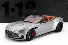 Silver convertible Aston Martin scale model car with tan interior and black wheels, available at Vroomi