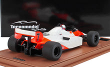 Red and white vintage race car model with number 7 on brown leather base, offered on Vroomi