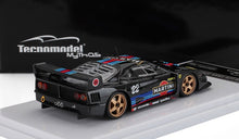 Black Ferrari F40 model car with Martini racing livery and gold wheels on a white display base, offered via Vroomi