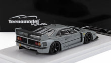 Gray Ferrari F40 race car model by Tecnomodel displayed with black wheels, rear spoiler, and mesh engine cover, available on Vroomi