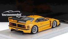 Yellow Ferrari F40 scale model with rear wing on display stand, available via Vroomi platform