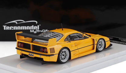 Yellow Ferrari F40 scale model with rear wing on display stand, available via Vroomi platform