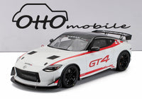 Voiture miniature Nissan Z GT4 NISMO blanche avec bandes rouges, présentée chez Vroomi pour les collectionneurs.