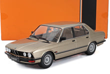 Metallic beige BMW 520i classic model car with detailed interior, offered through Vroomi