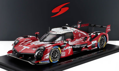 Red and white Toyota GR010 Hybrid race car model with racing decals, displayed on a stand, available on Vroomi