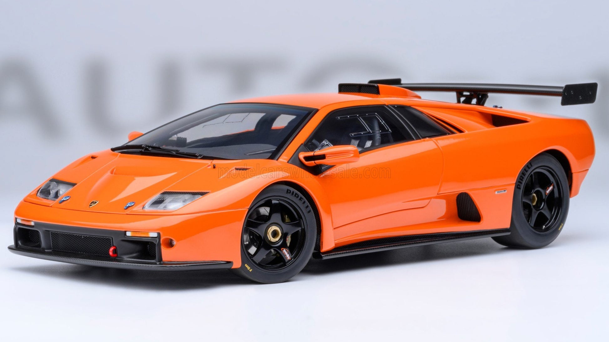 Orange Lamborghini Diablo sports car model with rear spoiler and black racing wheels available on Vroomi